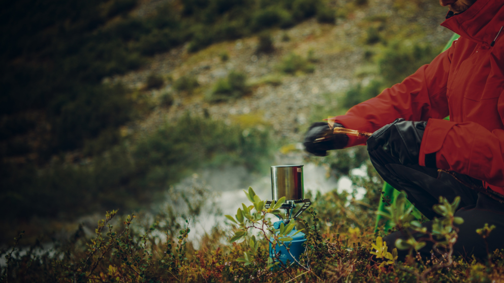 a man heating up a cup of tea for a survival remedy.