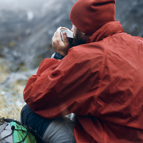 image of man drinking tea on a mountain for survival remedies