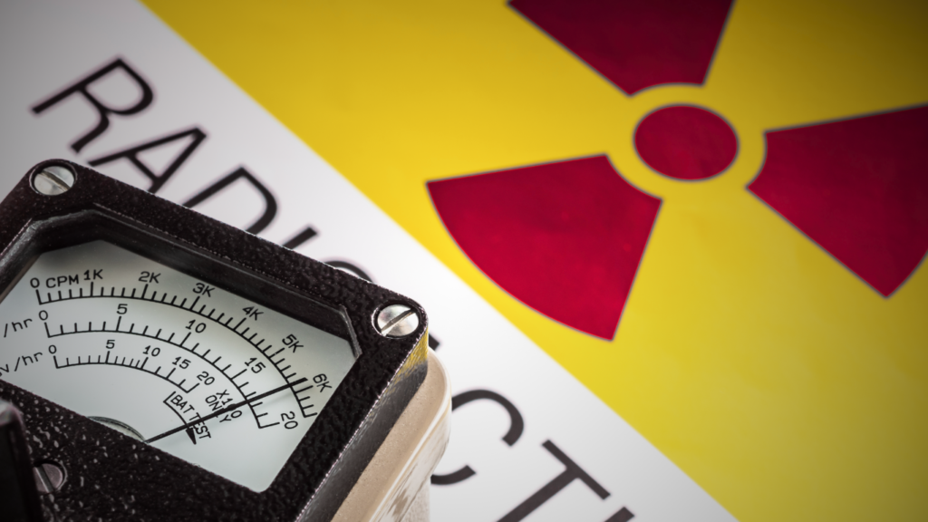 a picture of a geiger counter sitting on a radioactive sign 